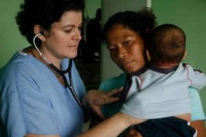 Dr. Beatriz E. Juncadella helping a child